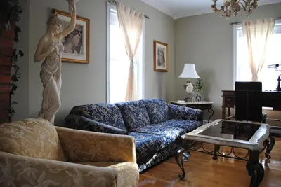 a living room with a couch and a statue of a woman at Auberge Marquis de Montcalm in Sherbrooke