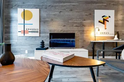 a living room with a table with a book on it at LiV MTL Urban in Montréal
