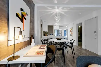 a dining room and living room with a table and chairs at LiV MTL Urban in Montréal