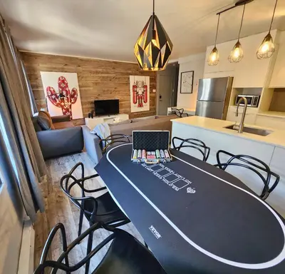 a table with a laptop on top of it in a kitchen at LiV MTL Urban in Montréal
