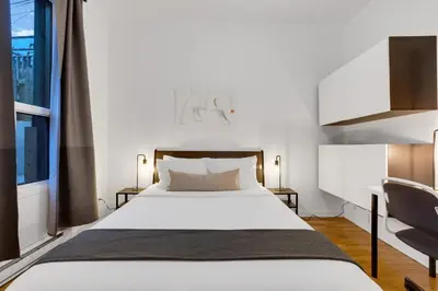 a bedroom with a white bed and a window at LiV MTL Avenue in Montréal