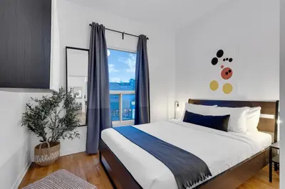 a bedroom with a large bed and a window at LiV MTL Avenue in Montréal