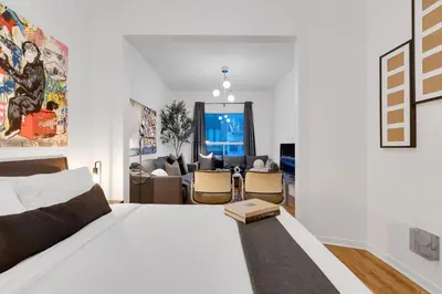 a bedroom with a bed and a living room at LiV MTL Avenue in Montréal