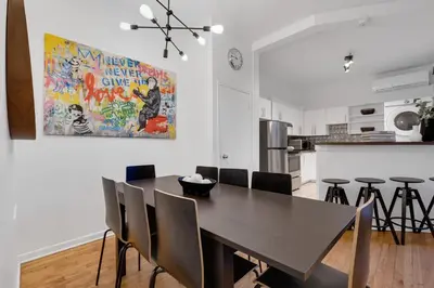 a kitchen and dining room with a table and chairs at LiV MTL Avenue in Montréal