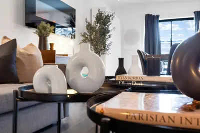 a living room with two white vases on a table at LiV MTL Plato in Montréal