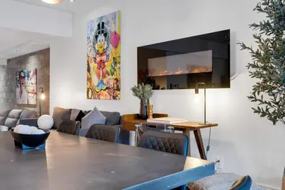 a dining room with a table and a couch at LiV MTL Plato in Montréal