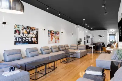 a waiting room with couches and tables in a store at LiV MTL Plaza in Montréal