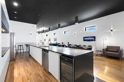 a large kitchen with a counter top and chairs at LiV MTL Plaza in Montréal