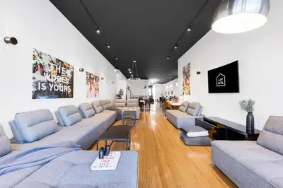 a waiting room with couches and chairs in a building at LiV MTL Plaza in Montréal