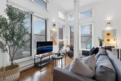 a living room with a couch and a fireplace at LiV MTL Main in Montréal