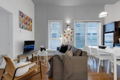 a living room with a couch and a dining room at LiV MTL Main in Montréal