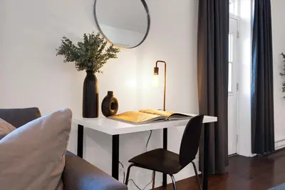 a room with a table with a mirror and a chair at LiV MTL Chic in Montréal