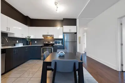 a kitchen with a table and chairs in a room at LiV MTL Chic in Montréal