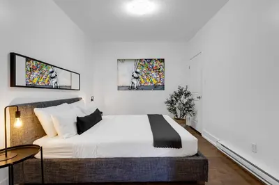 a bedroom with a bed and a table at LiV MTL Chic in Montréal