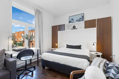a hotel room with a bed and a desk at LiV MTL MTL in Montréal