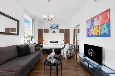 a living room with a couch and a bed at LiV MTL MTL in Montréal