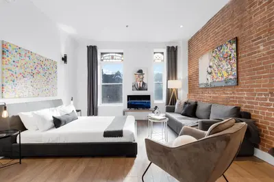 a bedroom with a bed and a brick wall at LiV MTL Downtown in Montréal