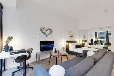 a living room with a couch and a bed at LiV MTL Downtown in Montréal