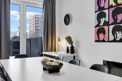 a dining room with a table and a large window at LiV MTL Downtown in Montréal