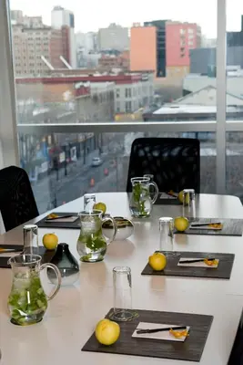 a table with glasses and mugs on it with a window at Hotel Zero 1 Montreal in Montréal