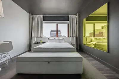 a bedroom with two beds and a large window at Hotel Zero 1 Montreal in Montréal