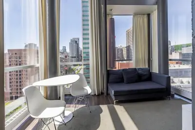 a living room with a couch and a table at Hotel Zero 1 Montreal in Montréal