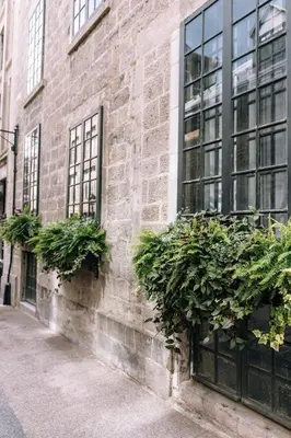 a brick building with plants on the side of it at Maison Sainte-Thérèse By Maisons & co in Montréal