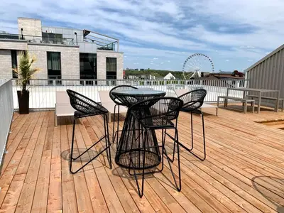 a patio with four chairs and a table on a deck at Maison Sainte-Thérèse By Maisons & co in Montréal