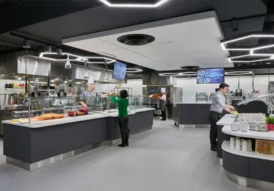a group of people in a kitchen preparing food at Campus1 MTL Student Residence Downtown Montreal in Montréal