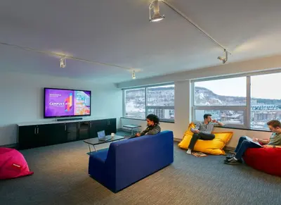 a group of people sitting in a living room watching tv at Campus1 MTL Student Residence Downtown Montreal in Montréal