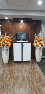 a room with two white vases with flowers and a tv at Baymont by Wyndham Montreal Airport in Dorval