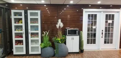 a room with a counter with a microwave and plants at Baymont by Wyndham Montreal Airport in Dorval