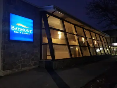 a building with a sign that reads banquet inn and suite at Baymont by Wyndham Montreal Airport in Dorval