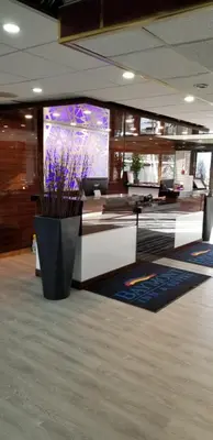 an office with a vase of purple flowers in a lobby at Baymont by Wyndham Montreal Airport in Dorval