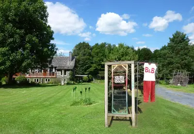 a sign in the grass in front of a house at B&B Pinorama in Sutton