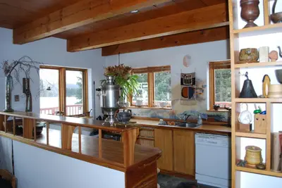 a kitchen with wooden cabinets and a counter top at B&B Pinorama in Sutton