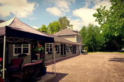 a house with a black awning in front of it at Studiotel Bromont in Bromont