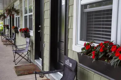 a house with flowers in the windows of a building at Studiotel Bromont in Bromont
