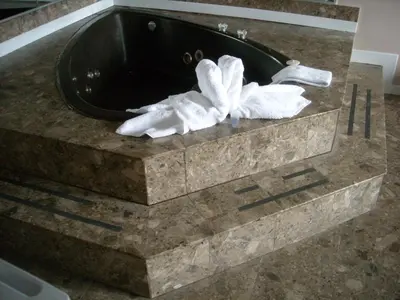 a black sink with a white towel on a counter at Grand Motel Saint-Hubert in Longueuil