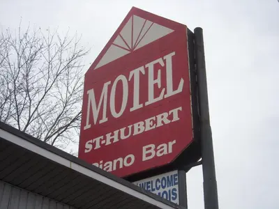 a sign on top of a motelinatorinatorinatoramboohibited anime bar at Grand Motel Saint-Hubert in Longueuil