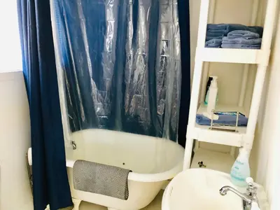 a bathroom with a shower and a toilet and a sink at L'Appartement de la Suite North Hatley in North Hatley