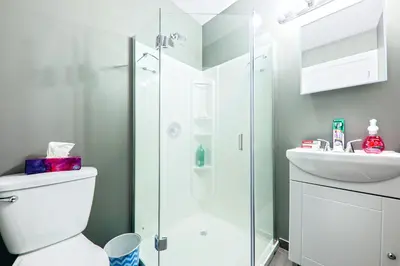 a bathroom with a shower and a toilet and a sink at HoMa Homestay Hotel by Olympic Stadium Montreal Auberge-Hostel in Montréal