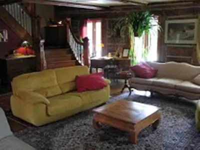 a living room with a couch and a coffee table at Auberge Restaurant La Mara in Saint-Joseph-de-Ham-Sud