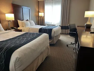 a hotel room with two beds and a window at Comfort Inn in Saint-Georges