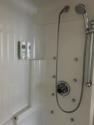 a bathroom with a shower with a shower head at Comfort Inn in Saint-Georges