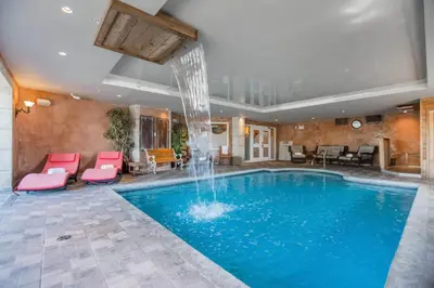 a swimming pool with a fountain in a hotel room at St Christophe Hotel & Spa, an Ascend Collection Hotel in Granby