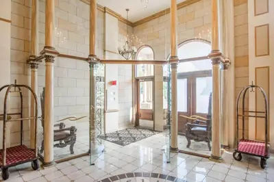 a large room with columns and a large mirror at St Christophe Hotel & Spa, an Ascend Collection Hotel in Granby