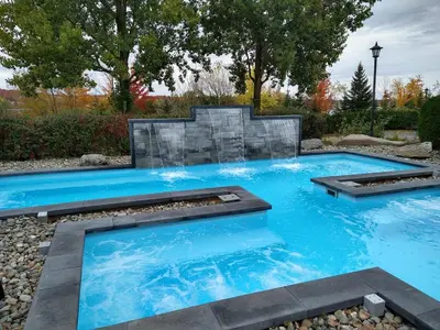 a swimming pool with blue water in a yard at St Christophe Hotel & Spa, an Ascend Collection Hotel in Granby
