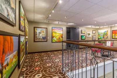 a hallway with many paintings on the walls at Quality Inn & Suites in Victoriaville