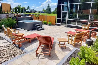a patio with a table and chairs and a hot tub at Quality Inn & Suites in Victoriaville